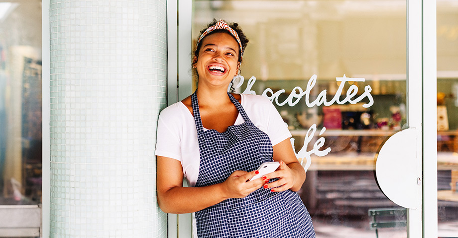 Happy woman in front of Chocolates Cafe