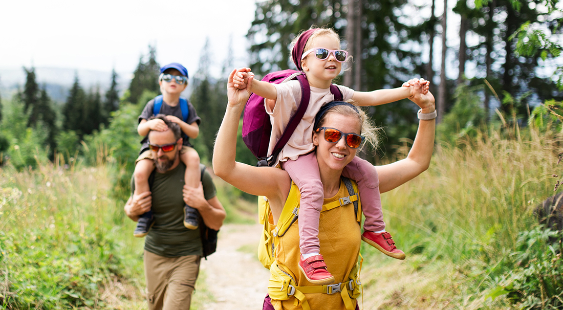 Family hiking together outdoors, illustrating healthy and active lifestyles.