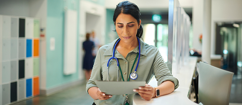 A female doctor reviews charts in a hospital, supporting informed care decisions and patient health management.