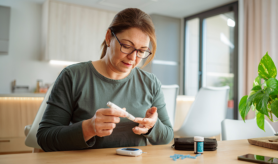 Woman measuring blood sugar with device