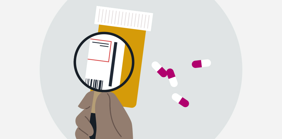 A magnifying glass held over the label of a prescription bottle