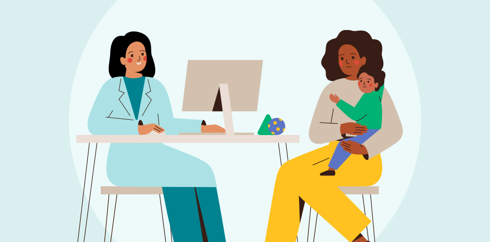 A doctor sitting with a patient and their child