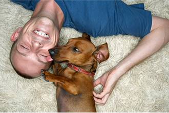 Man and dog lying down on floor