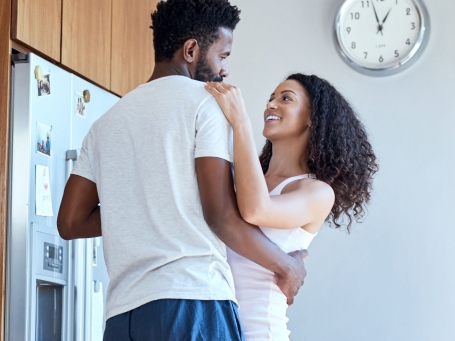 Man and woman hug in kitchen